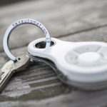 White Key Automation remote control attached to keyring and keys on wooden surface, found in Prestons, New South Wales, Australia.